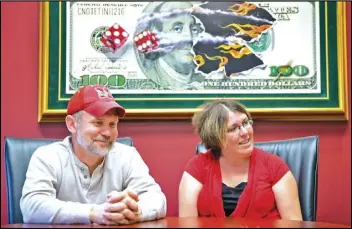  ?? KENT SIEVERS /OMAHA WORLD-HERALD VIA AP ?? Powerball lottery winners David (left) and Erica Harrig, of Gretna, Neb., speak during an interview at the law office of their attorney Darren Carlson in Omaha, Neb., in 2013.