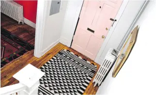  ??  ?? Painting the door millennial pink adds a touch of whimsy to the foyer, while a gold-framed octagonal mirror and patterned rug bring the space together. Total budget: $100.