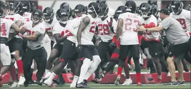  ?? THE ASSOCIATED PRESS FILE PHOTOS ?? The Atlanta Falcons defensive unit runs an agility drill at the NFL football teams practice facility in Flowery Branch, Ga.