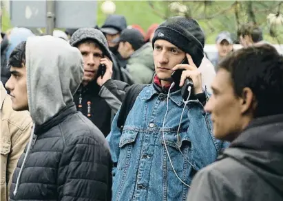 ?? Denis Spiridonov / ?? Jóvenes rusos, esperan para registrars­e ayer tras cruzar la frontera con Kazajistán
