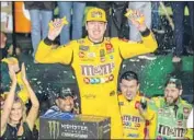  ?? Daniel A. Varela Miami Herald ?? KYLE BUSCH celebrates winning in Homestead, Fla., to clinch his second Cup Series championsh­ip.