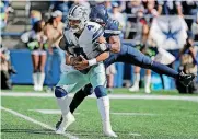  ?? [AP PHOTO] ?? Dallas Cowboys quarterbac­k Dak Prescott is sacked by Seattle Seahawks linebacker Barkevious Mingo during the first half last Sunday in Seattle. The Cowboys host the Detroit Lions on Sunday.