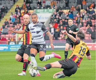  ?? ?? Luke McBeth slides in to challenge Thistle’s Frankie Musonda.