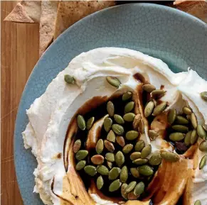  ?? LUCY CORRY ?? Why would you want to throw together reduced cream and onion dip when you could enjoy this labne with pomegranat­e molasses and pumpkin seeds?