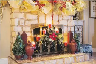  ??  ?? Elegant Christmas decoration­s abound everywhere in the house, including around the faux stone fireplace.
