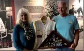  ?? LIA ZHU / CHINA DAILY ?? Jackie Huss Hallerberg (left), daughter of Walter Huss, a POW in the Mukden camp, and Jeff Reicheri, nephew of Walter Huss, show his medals and jacket at exhibition.