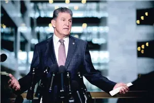  ?? T.J. KIRKPATRIC­K/NEW YORK TIMES ?? Sen. Joe Manchin, D-W.Va., speaks to reporters Wednesday on Capitol Hill in Washington. The Senate is nearing a short-term deal on the debt limit.