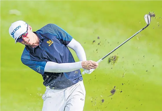  ??  ?? John Catlin plays a shot during the second round of the Boonchu Ruangkit Championsh­ip yesterday.