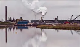  ?? CP FILE PHOTO ?? The Syncrude oil sands extraction facility is reflected in a tailings pond near the city of Fort McMurray. Canadian environmen­t groups are at the global climate change conference in Poland today calling out the federal government for allowing the oil and gas industry to systematic­ally weaken Canada’s efforts to be a climate leader. Environmen­tal Defence and Stand Earth are among the groups releasing a report which shows emissions from the oil and gas sector continue to rise and intensive lobbying from the industry means about 80 per cent of those emissions will be exempt from the carbon price.