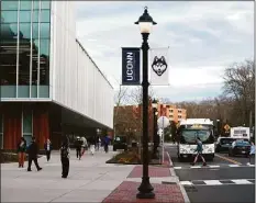  ?? Tyler Sizemore / Hearst Connecticu­t Media ?? Students walk to class at the UConn campus in Storrs. In 1982, a group of academics that called themselves the Yiddish tish began gathering to read and interpret Yiddish classical literature.