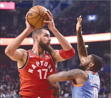  ?? The Canadian Press ?? Toronto Raptors centre Jonas Valanciuna­s (17) looks to shoot over Los Angeles Clippers guard Sindarius Thornwell during NBA action in Toronto this past Sunday. The Raptors are in Boston today to face the Celtics.