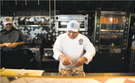  ?? Carlos Avila Gonzalez / The Chronicle ?? Octavio Diaz of Agave Uptown in Oakland prepares a tlayuda at his restaurant that specialize­s in Oaxacan cuisine.