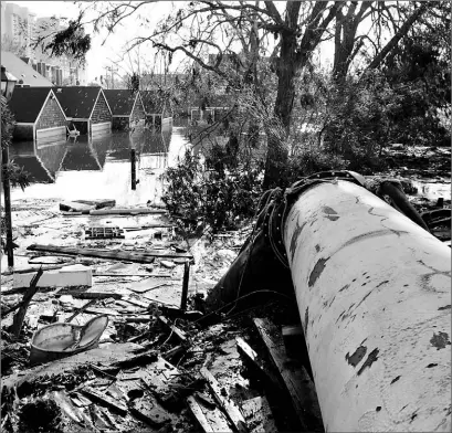  ?? STEVEN SENNE/ AP PHOTO ?? Water is pumped out of a flooded New Orleans subdivisio­n this week through a pipe that pumps out 27,000 gallons per minute.