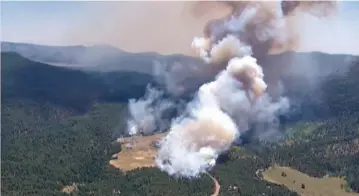  ?? COURTESY KRQE-TV ?? ABOVE: Smoke rises Thursday from the Cajete Fire in the Jemez Mountains in Sandoval County. As of Thursday evening, the fire had grown to 600 acres, and forced road closures and the evacuation of hundreds of area residents along N.M. 4.