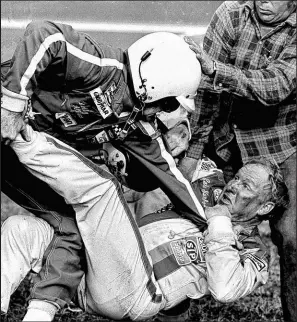  ?? Ric Feld The Associated Press file ?? Bobby Allison, left, and Cale Yarborough fight after the Daytona 500 in Daytona Beach, Fla., on Feb. 18, 1979. Forty years later, it still resonates as one of the most important days in NASCAR history.