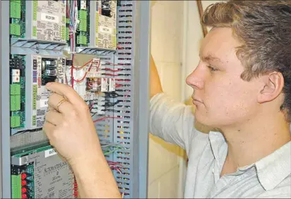  ?? DAVE STEWART/THE GUARDIAN ?? Nic Cahill was hired recently to complete energy audits on all facilities owned by the City of Charlottet­own. He oversaw the implementa­tion of an automated heating system at one of its largest buildings, the public works garage on MacAleer Drive. This complex maze of circuits and wiring could reduce the building’s heating costs by 20 per cent.