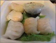  ?? (Arkansas Democrat-Gazette/Eric E. Harrison) ?? Five plump shrimp dumplings make up an appetizer order at Sushi Cafe. The soy-ginger dipping sauce also served for the sashimi.