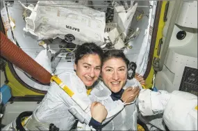  ?? NASA / Associated Press ?? In this photo released by NASA on Oct. 18, U.S. astronauts Jessica Meir, left, and Christina Koch pose for a photo in the Internatio­nal Space Station. The astronauts who took part in the first allfemale spacewalk are still uplifted by all the excitement down on Earth. Meir said Oct. 21 that when she floated outside, she wasn’t thinking about whether she was going out with a man or woman because everyone is held to the same standard. Nonetheles­s, she says it was extra special being accompanie­d by Koch, a close friend.