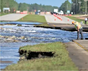  ?? THE STAR-NEWS PHOTO VIA AP ?? ROAD TO NOWHERE: Flooding from Sutton Lake washes away a section of U.S. 421 in Wilmington, N.C., on Friday as rains from Hurricane Florence continue to wreak havoc days after the storm left the Carolinas.