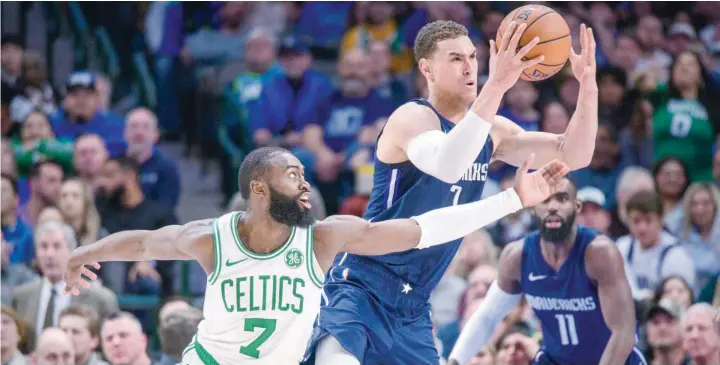 ?? — USA Today Sports ?? Boston Celtics guard Jaylen Brown (7) and Dallas Mavericks forward Dwight Powell (7) fight for the loose ball during the second half at the American Airlines Center.