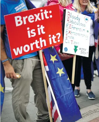  ?? MATT DUNHAM/AP FILES ?? Anti-Brexit supporters protest near the Houses of Parliament in London in June. A hard Brexit would carry the risk of adverse ripple effects on the European and global economies and equity markets.