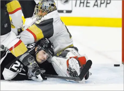  ?? Mark J. Terrill ?? The Associated Press Kings right wing Dustin Brown, left, lays on the ice after scoring the winning goal past Golden Knights goaltender Marc-andre Fleury in overtime Monday night at Staples Center in Los Angeles. The Kings won 3-2.