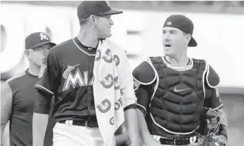  ?? LYNNE SLADKY/AP ?? Marlins’ starting pitcher Robin Lopez, left, walks with catcher J.T. Realmuto before a game against the Mets in June. Realmuto is coming off his best season with .277 batting average, 21 home runs and 74 RBIs.