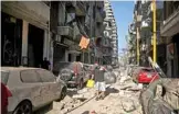  ??  ?? A man collects his belongings in the trendy partially destroyed Beirut neigh- borhood of Mar Mikhael.