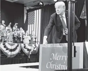  ?? THE ASSOCIATED PRESS ?? President Donald Trump points to a Merry Christmas sign as he arrives Wednesday to speak about tax reform at the St. Charles Convention Center in St. Charles, Mo.