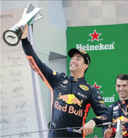  ?? ANDY WONG/THE ASSOCIATED PRESS ?? Red Bull driver Daniel Ricciardo raises his trophy after winning the Formula One Chinese Grand Prix at the Shanghai Internatio­nal Circuit on Sunday in Shanghai.