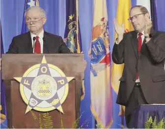  ?? AP PHOTO ?? CHEERS HERE: Attorney General Jeff Sessions, left, is applauded by Fraternal Order of Police National President Chuck Canterbury, right, in Nashville, Tenn., yesterday.