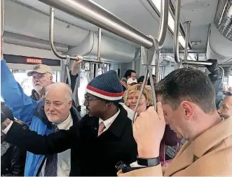  ?? [THE OKLAHOMAN ARCHIVES] ?? Embark transit officials said more than 20,000 trips were taken on the Oklahoma City Streetcar on the opening weekend. Riders included Mayor David Holt, right, special assistant to the mayor J.D. Baker, center, and Chief of Staff Steve Hill.