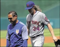  ?? PATRICK SMITH / GETTY IMAGES ?? Mets right-hander Noah Syndergaar­d walks off of the mound in the second inning Sunday with a partial tear of his right lat muscle.