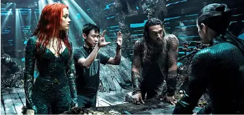  ??  ?? James gives directions to ‘Aquaman’ stars Jason Momoa and Amber Heard.