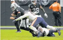  ?? ?? Khalil Mack tackles Las Vegas Raiders quarterbac­k Derek Carr.