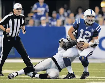  ?? Doug Mcschooler / Associated Press ?? Jason Hunter sacks Andrew Luck in the second half, one of the Raiders’ four sacks in a game that marked a turnaround for Oakland’s defense after four poor showings in the preseason.