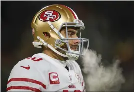  ?? NHAT V. MEYER — BAY AREA NEWS GROUP FILE ?? The San Francisco 49ers' Jimmy Garoppolo warms up on the sidelines during their game against the Green Bay Packers in the second quarter of an NFC divisional playoff game at Lambeau Field in Green Bay, Wis., on Jan. 22.