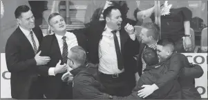  ?? CP PHOTO ?? Toronto Marlies head coach Sheldon Keefe, second left, celebrates with his coaching and training staff after defeating the Texas Stars to win the Calder Cup championsh­ip in Toronto.