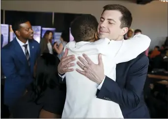  ?? JOHN LOCHER — THE ASSOCIATED PRESS ?? Democratic presidenti­al candidate former South Bend Mayor Pete Buttigieg embraces Hannah Brown at the Nevada Black Legislativ­e Caucus Black History Awards brunch Sunday in Las Vegas.