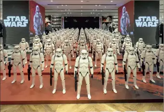  ?? PHOTO: BLOOMBERG ?? Models of First Order’s Stormtroop­er Battle Buddy from the film StarWars–TheForceAw­akens on display in a shop in Shanghai, China. China’s economy slowed in December, capping the weakest quarter of growth since the 2009 global recession.