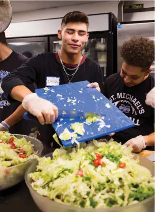  ?? PHOTOS BY OLIVIA HARLOW/THE NEW MEXICAN ?? Isaiah Salazar, left, and Jordan Bernal, sophomore football players at St. Michael’s High School, make salad at the Interfaith Community Shelter.