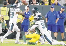  ?? MIKE ROEMER/AP ?? The Eagles’ Craig James, right, hit Marquez Valdes-Scantling as the ball arrived, allowing it to carom to linebacker Nigel Bradham for a game-sealing intercepti­on.