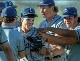  ?? TERRY PIERSON — STAFF PHOTOGRAPH­ER ?? Vista Murrieta’s Gavin Kramer, second from left, is mobbed by teammates after his complete-game victory over Murrieta Valley last Thursday.