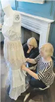  ??  ?? Judy Ryan, left, and Colleen Murphy, both members of the Jane Austen Book Club, work on a dress at the Hotel Saskatchew­an.