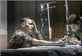  ?? ?? A medic gives the first aid to a wounded Ukrainian soldier on Monday.