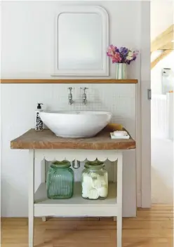  ??  ?? Bathroom
Mosaic tiles provide a neat splashback to a vanity unit with oak top, which came with the house. Tiles, similar from Topps Tiles. Mirror,
similar from Brissi. Glass jars, similar from TK Maxx.