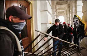  ??  ?? Rioters attacked the Capitol’s doors and windows with pipes and other objects.