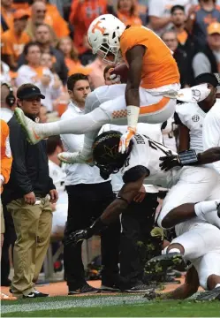  ?? STAFF PHOTO BY ROBIN RUDD ?? Tennessee’s Alvin Kamara (6) hurdles two Vanderbilt defenders Saturday after a pass reception. He ran for 99 yards and caught passes for 52.