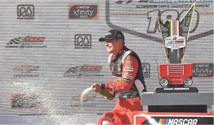  ?? GETTY IMAGES ?? Christophe­r Bell celebrates his victory in the NASCAR Xfinity Series CTech Manufactur­ing 180 Saturday at Road America.