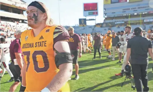  ?? PHOTOS BY JOE RONDONE/THE REPUBLIC ?? Arizona State offensive lineman Emmit Bohle walks off the field after Saturday’s loss to Oregon State at Sun Devil Stadium.